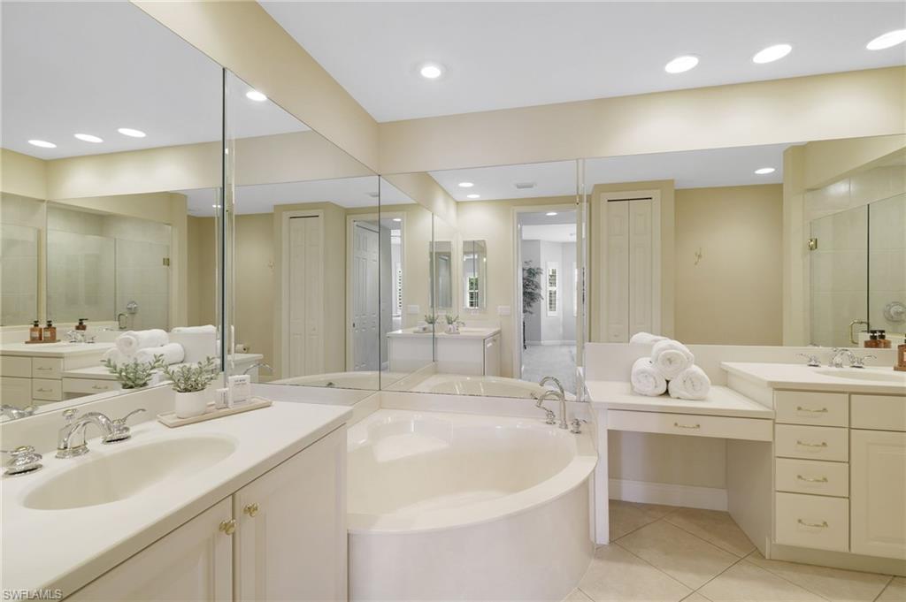 19741 Marino Lake Circle, Unit 802 Miromar Lakes, FL 33913 - Photo 13 of 38 a bathroom with a double vanity sink mirror and double