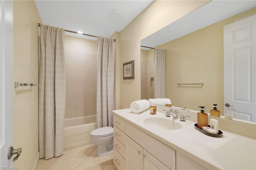 19741 Marino Lake Circle, Unit 802 Miromar Lakes, FL 33913 - Photo 17 of 38 a bathroom with a granite countertop sink toilet and shower