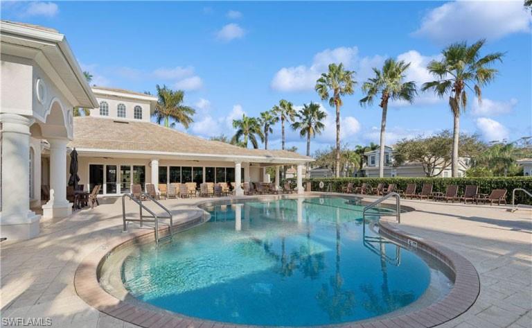 19741 Marino Lake Circle, Unit 802 Miromar Lakes, FL 33913 - Photo 32 of 38 a view of a swimming pool with chairs