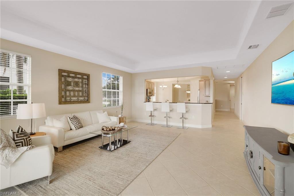 19741 Marino Lake Circle, Unit 802 Miromar Lakes, FL 33913 - Photo 5 of 38 a living room with furniture and a table