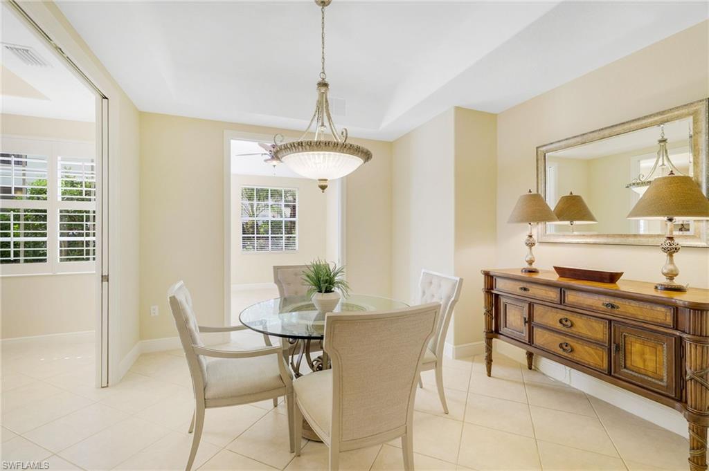 19741 Marino Lake Circle, Unit 802 Miromar Lakes, FL 33913 - Photo 7 of 38 a view of a dining room with furniture window and outside view