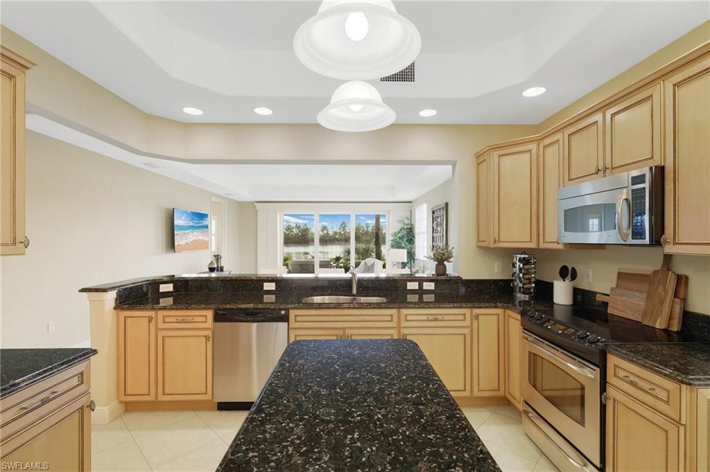 19741 Marino Lake Circle, Unit 802 Miromar Lakes, FL 33913 - Photo 10 of 38 a kitchen with a sink stove and cabinets