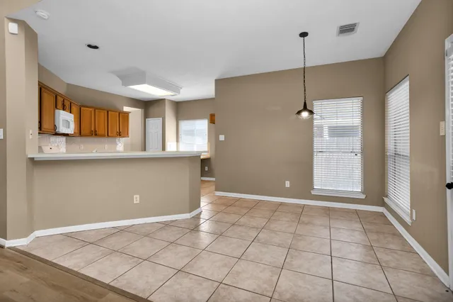 a view of a kitchen with a sink and a window wooden floor