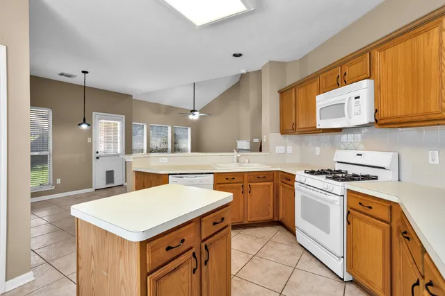 a kitchen with stainless steel appliances a stove a sink and a refrigerator