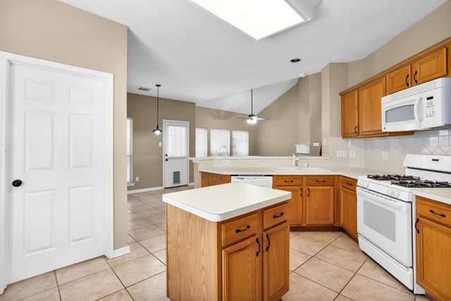 a kitchen with stainless steel appliances granite countertop a sink and a stove top oven