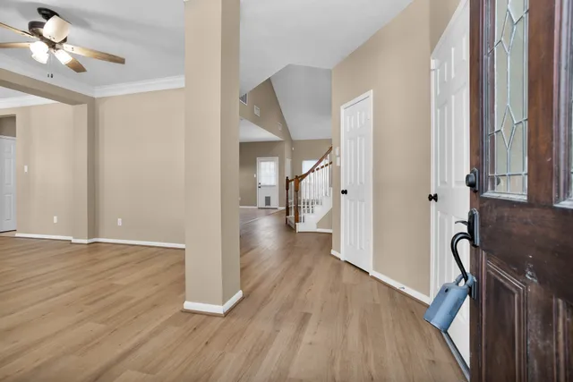 a view of a hallway with wooden floor