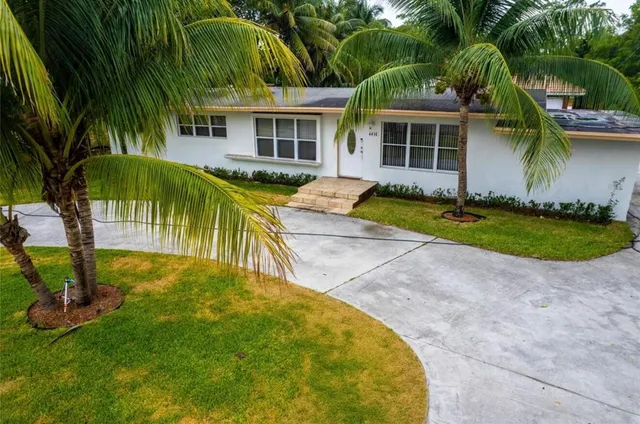 a view of a house with pool and sitting area