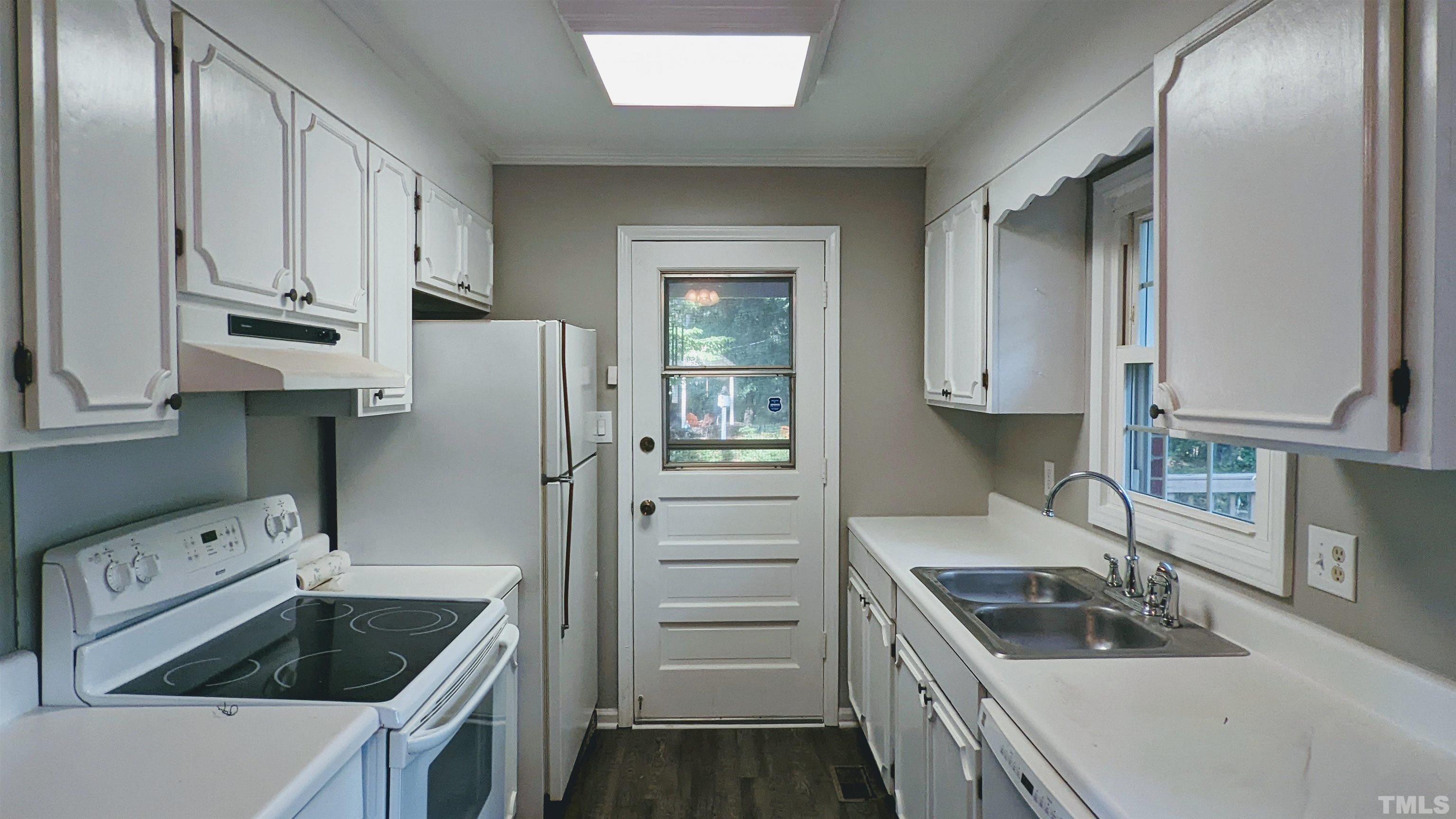 4901 Vallery Place Raleigh, NC 27604 - Photo 17 of 22 a kitchen with white cabinets and stainless steel appliances