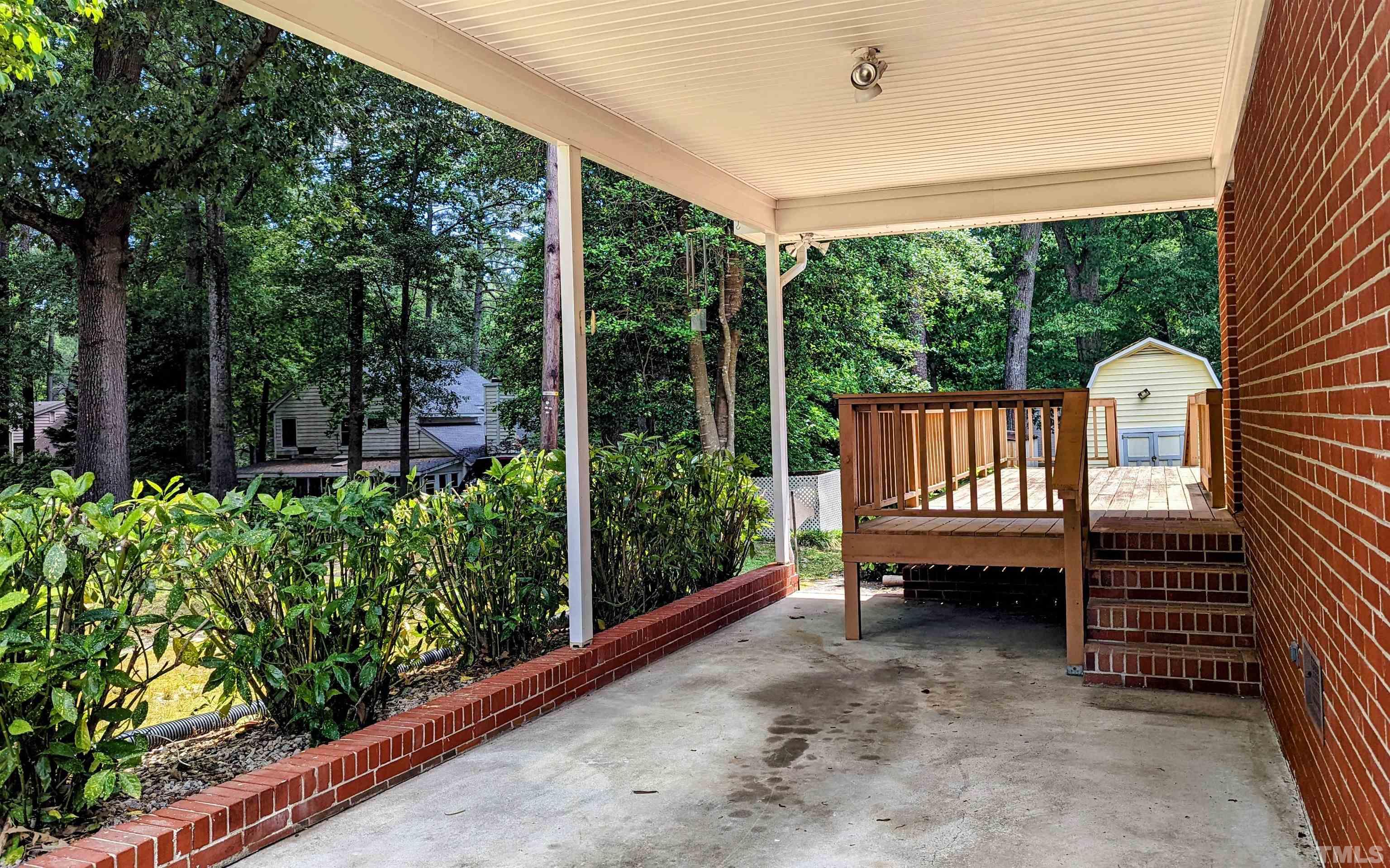 4901 Vallery Place Raleigh, NC 27604 - Photo 4 of 22 a view of a porch with furniture and garden
