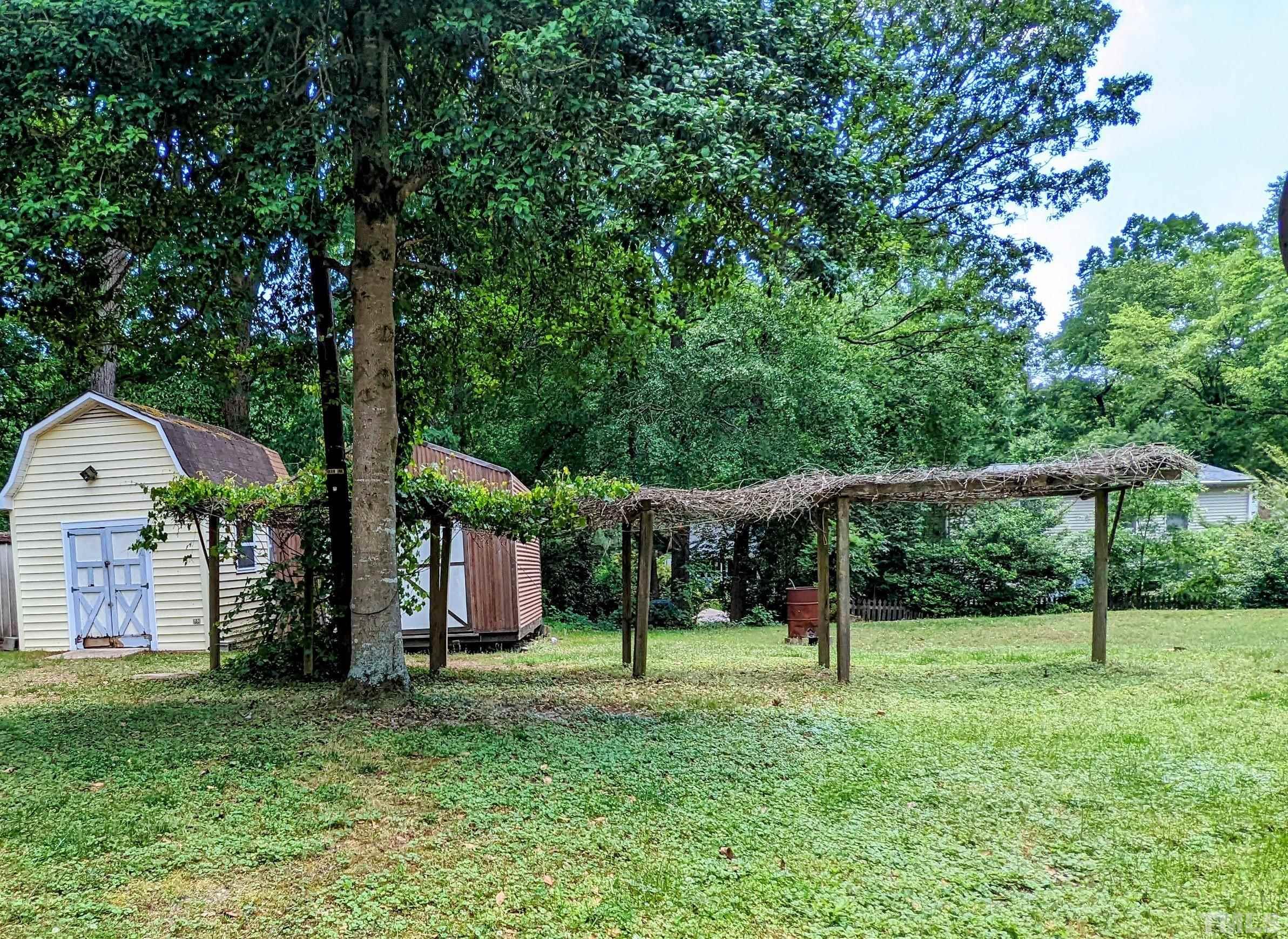 4901 Vallery Place Raleigh, NC 27604 - Photo 10 of 22 a view of a house with backyard and a tree