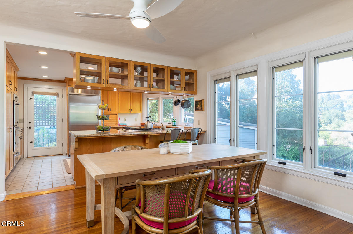 1659 Kaweah Drive Pasadena, CA 91105 - Photo 17 of 46 a dining room with stainless steel appliances a table and chairs with wooden floor