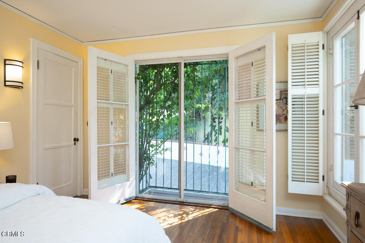 1659 Kaweah Drive Pasadena, CA 91105 - Photo 32 of 46 a bedroom with a bed and glass door