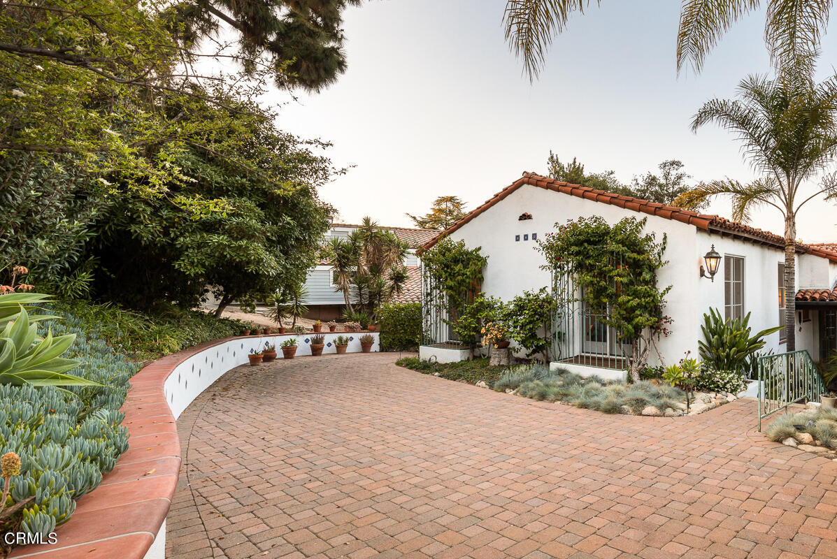 1659 Kaweah Drive Pasadena, CA 91105 - Photo 42 of 46 a view of a white house with a big yard and large trees