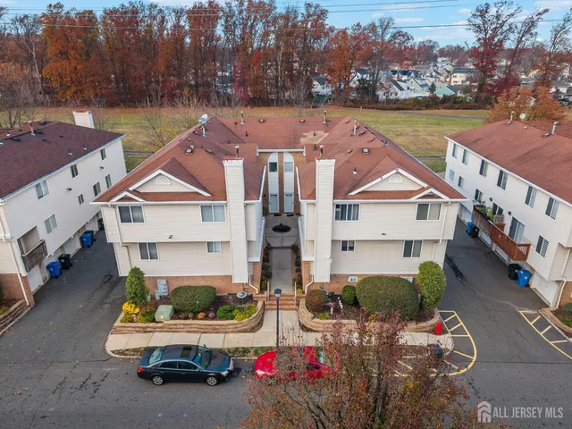 an aerial view of a house with swimming pool and a yard