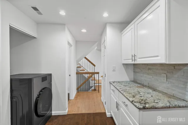 a view of a hallway with washer and dryer