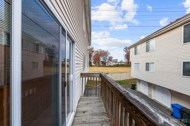 a view of a balcony with wooden floor and fence