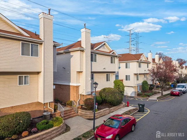 a view of multiple houses with a street
