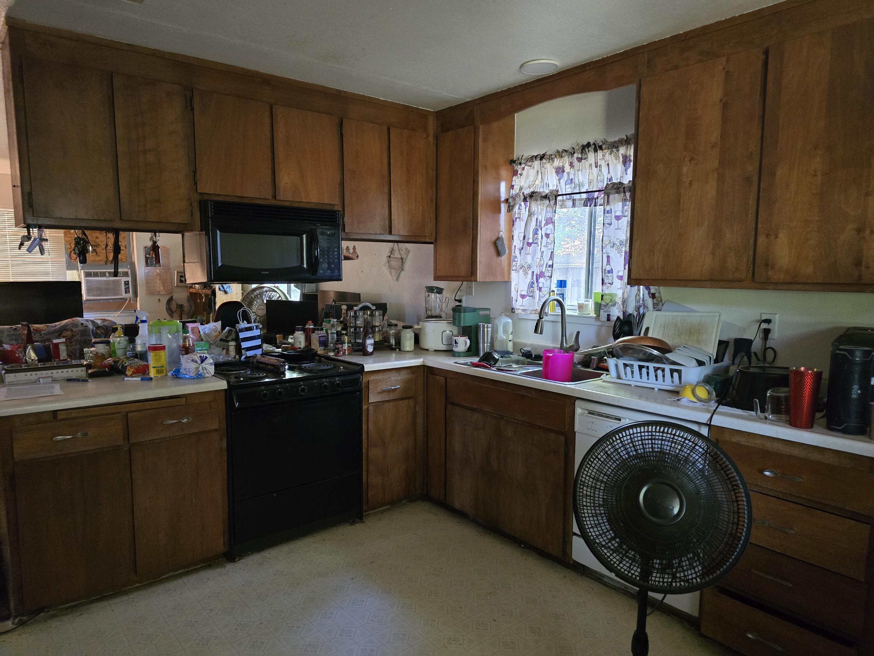 1591 Canby Road Redding, CA 96002 - Photo 2 of 15 a kitchen with sink cabinets and window