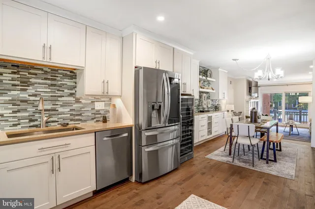 a kitchen with kitchen island a counter top space cabinets and stainless steel appliances