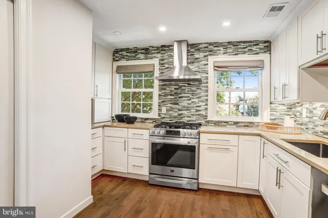 a kitchen with stainless steel appliances granite countertop a stove and a sink