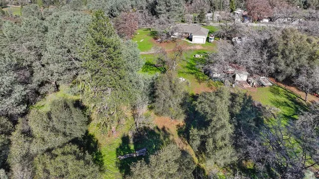 a view of a field with trees in the background