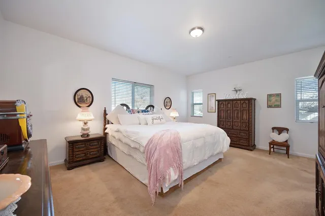 a bed room with a bed and a chair