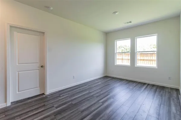 a kitchen with stainless steel appliances a refrigerator a stove top oven and wooden floors