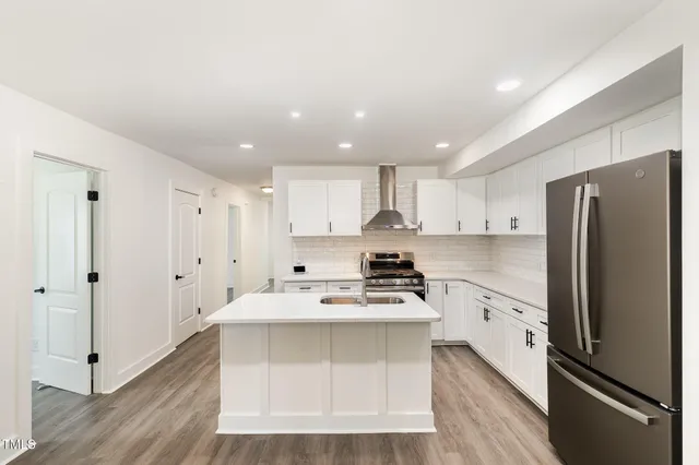 a kitchen with stainless steel appliances a refrigerator stove microwave and cabinets