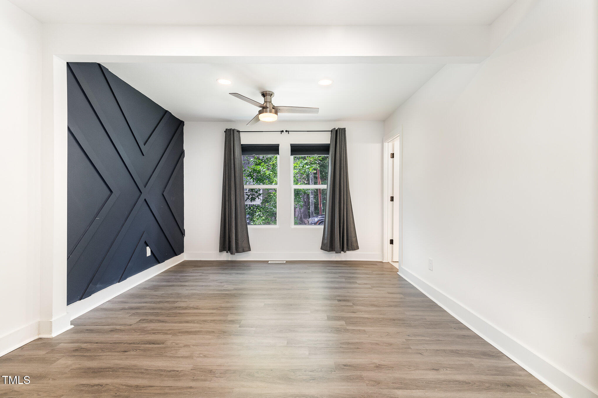 819 Cumberland Street Raleigh, NC 27610 - Photo 12 of 21 a view of an empty room with wooden floor and a window