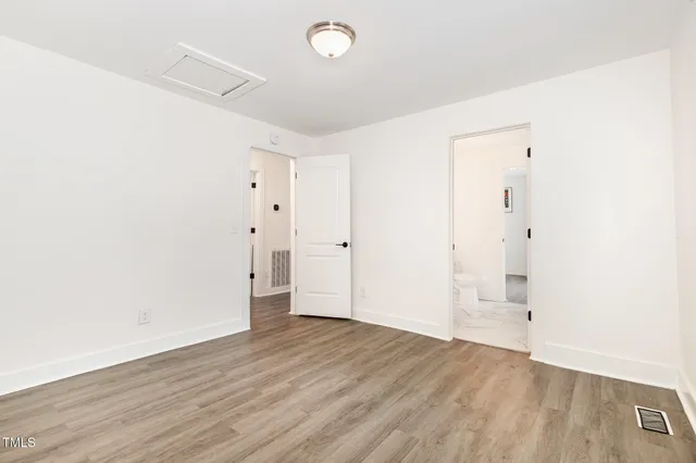 an empty room with wooden floor