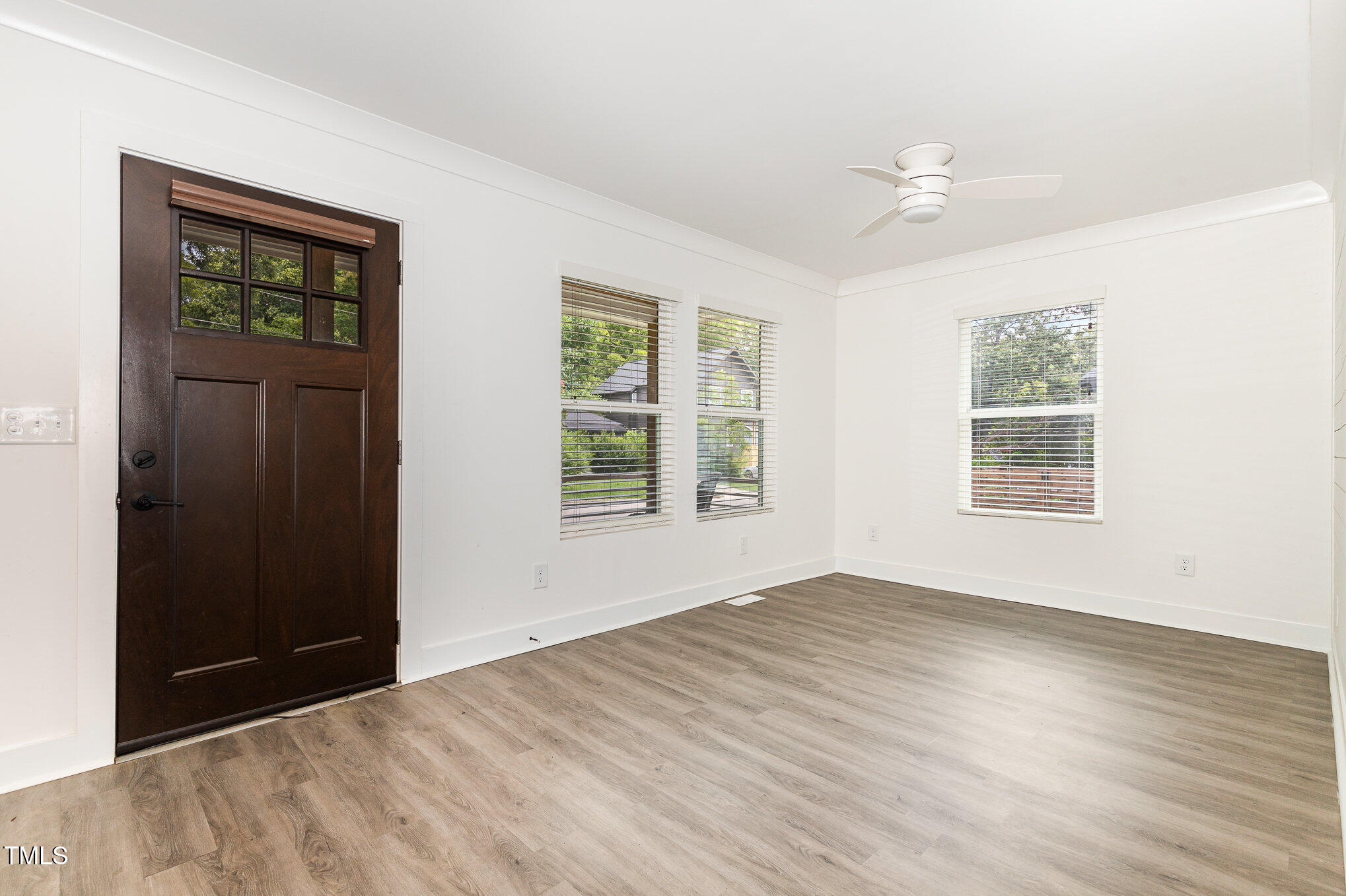 819 Cumberland Street Raleigh, NC 27610 - Photo 2 of 21 a view of an empty room with wooden floor and a window