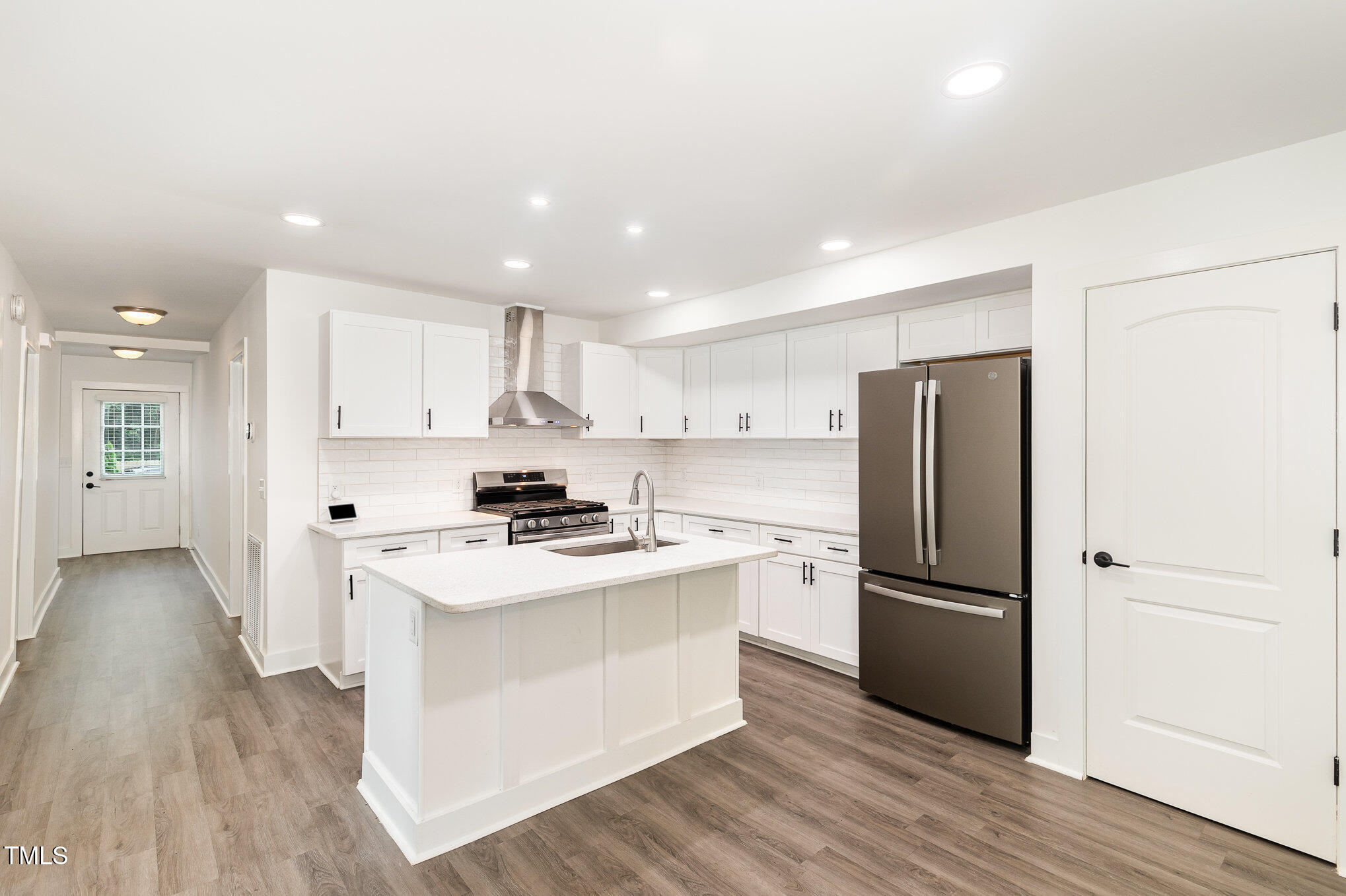 819 Cumberland Street Raleigh, NC 27610 - Photo 8 of 21 a kitchen with stainless steel appliances a refrigerator sink and cabinets