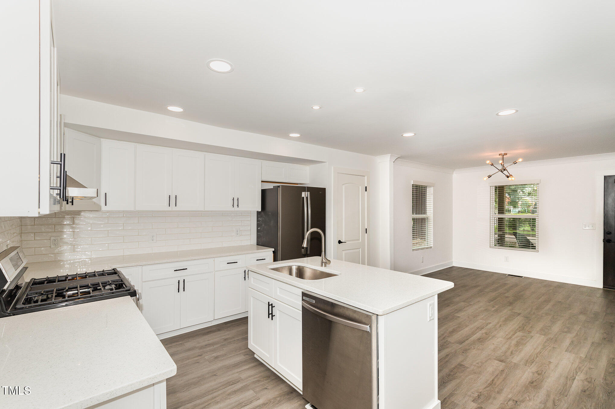 819 Cumberland Street Raleigh, NC 27610 - Photo 9 of 21 a kitchen with a stove a sink and a refrigerator