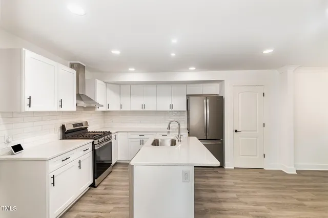 a kitchen that has a sink and a stove in it
