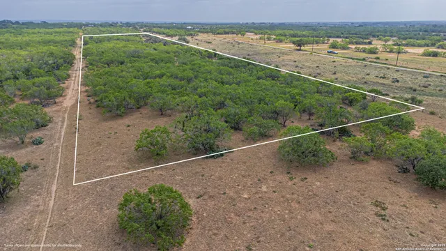 a view of a field with an ocean view