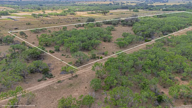 a view of a field with wooden fence