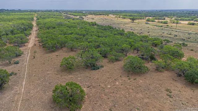 a view of a lake with beach and outdoor space