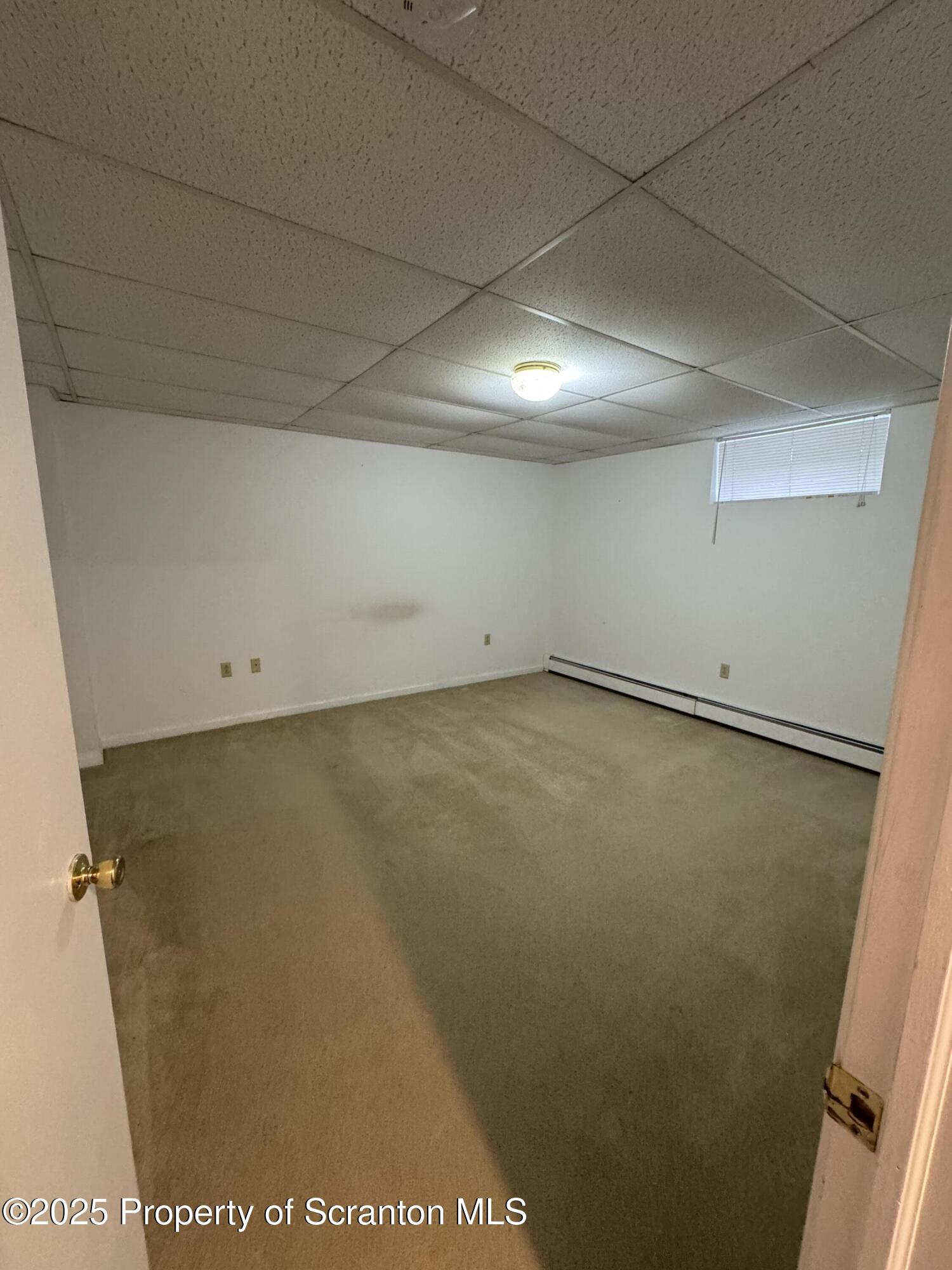 622 Terrace Street, Unit B Dunmore, PA 18512 - Photo 14 of 15 an empty room with a wooden door