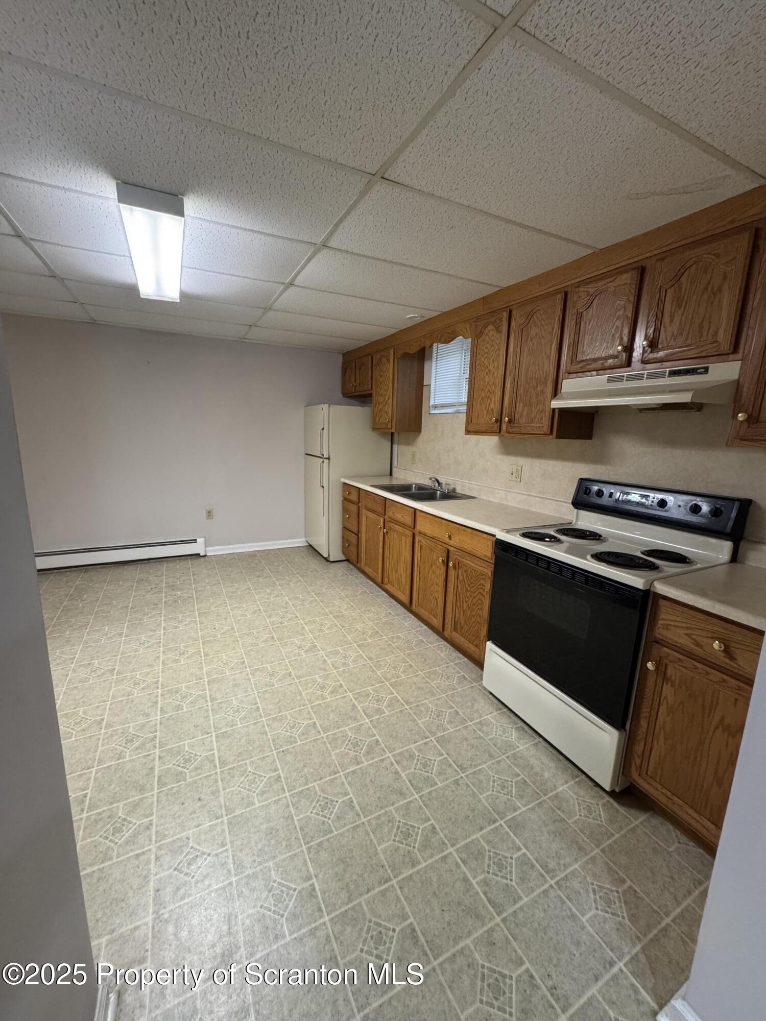 622 Terrace Street, Unit B Dunmore, PA 18512 - Photo 4 of 15 a kitchen with stainless steel appliances granite countertop a stove a sink and a refrigerator