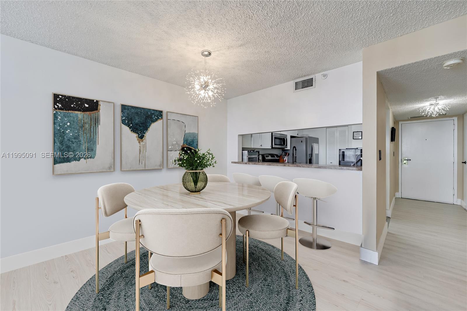 555 Northeast 15th Street, Unit 33G Miami, FL 33132 - Photo 5 of 18 a view of a dining room with furniture and chandelier