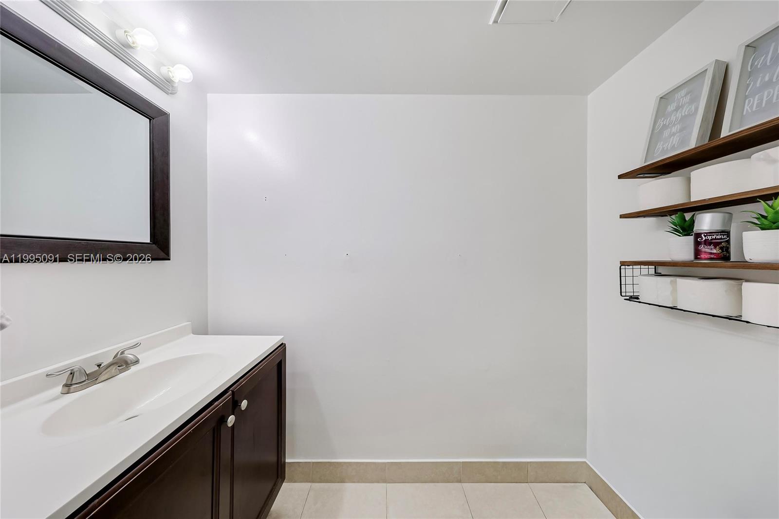 555 Northeast 15th Street, Unit 33G Miami, FL 33132 - Photo 7 of 18 a bathroom with a sink and a mirror