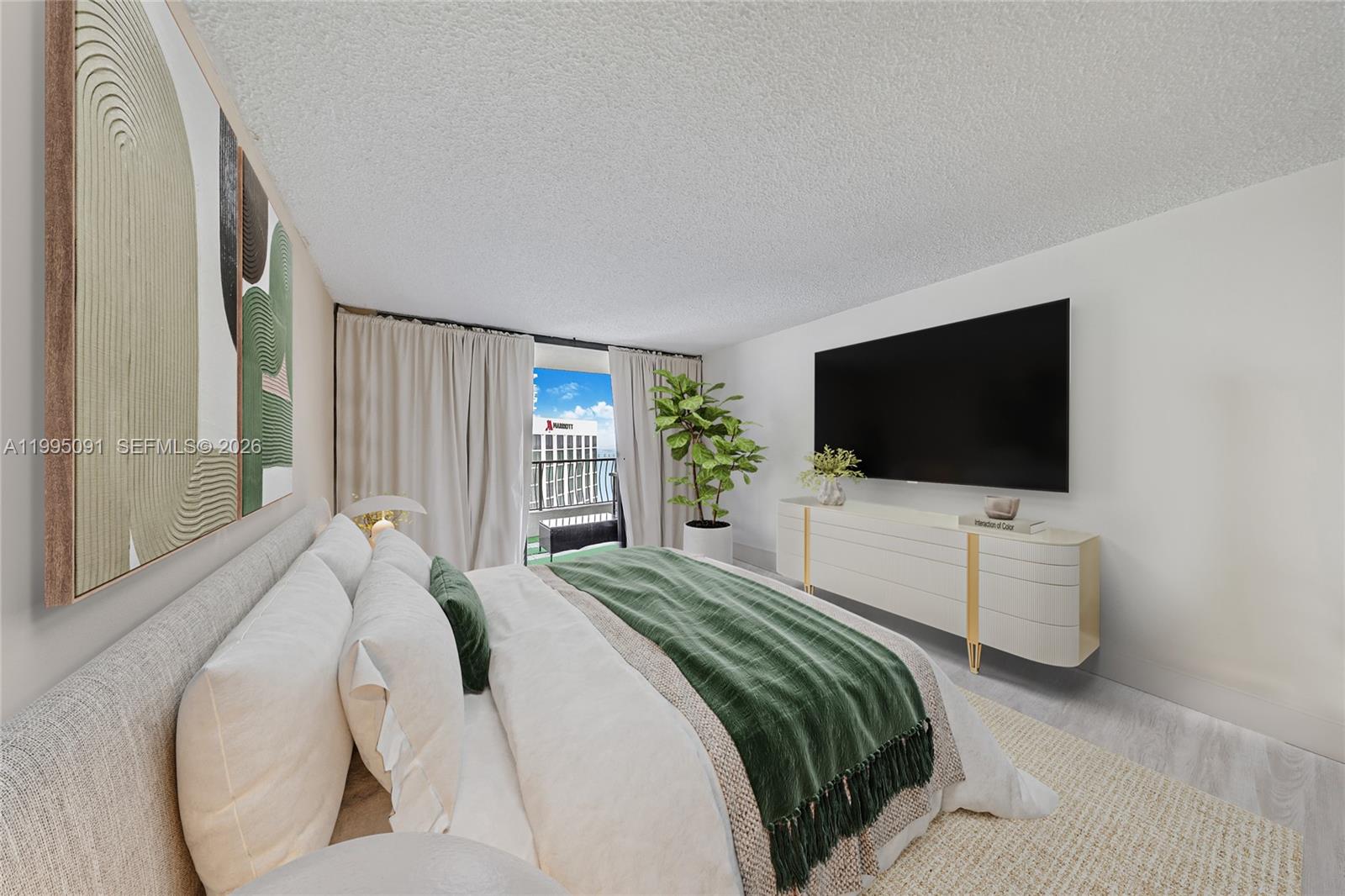 555 Northeast 15th Street, Unit 33G Miami, FL 33132 - Photo 8 of 18 a bedroom with a bed and a flat screen tv