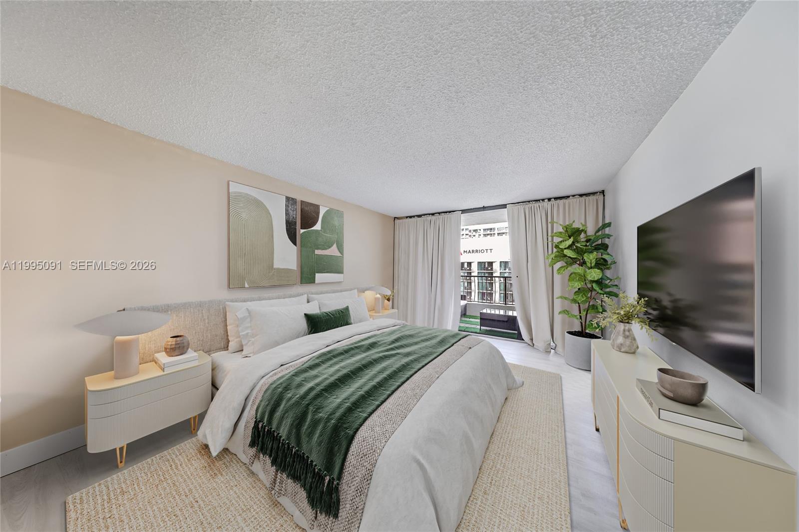 555 Northeast 15th Street, Unit 33G Miami, FL 33132 - Photo 9 of 18 a bedroom with a bed and a flat screen tv