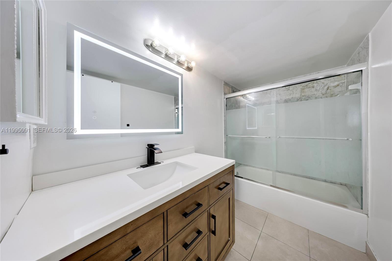 555 Northeast 15th Street, Unit 33G Miami, FL 33132 - Photo 10 of 18 a bathroom with a sink a vanity and a mirror