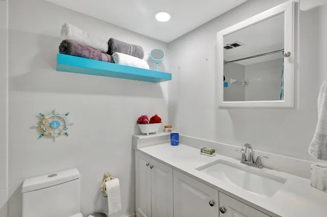 a bathroom with a sink mirror and vanity