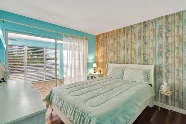 a bedroom with a large bed and a large window