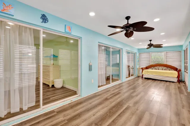 a view of a livingroom with a ceiling fan and window