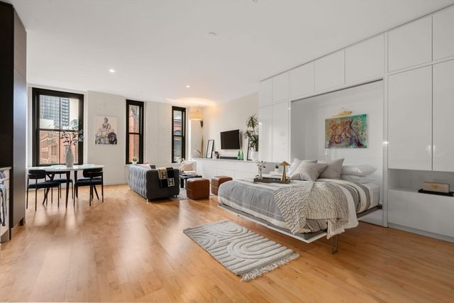 a spacious bedroom with a bed a couch and a table