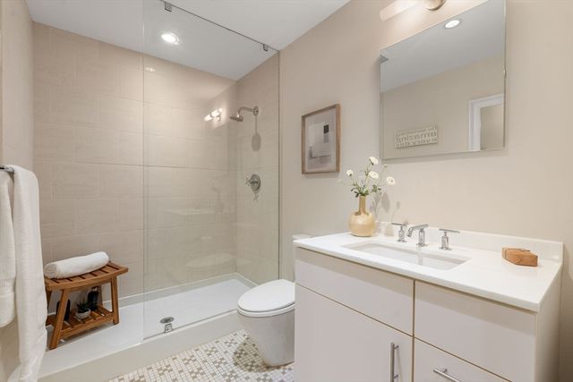 a bathroom with a sink a toilet and shower