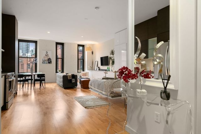 a view of living room with furniture and wooden floor